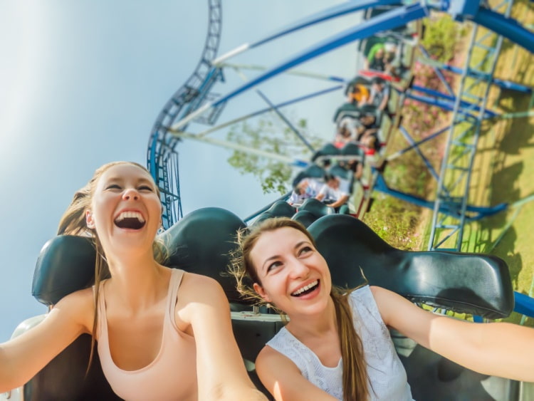 Two female students enjoy a roller coaster ride together