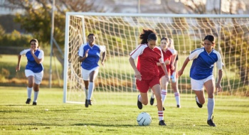Two women's soccer teams compete in a match