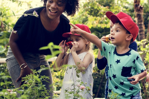 Young students explore on an outdoor field trip with their teacher